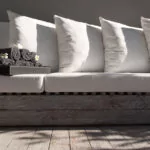 Elegant luxury outdoor lounge seating at The Lombok Lodge, a luxury resort in Lombok, featuring plush white cushions and a serene ambiance