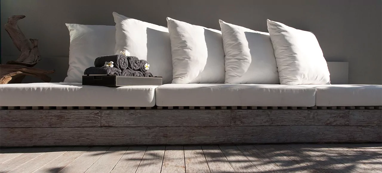 Elegant luxury outdoor lounge seating at The Lombok Lodge, a luxury resort in Lombok, featuring plush white cushions and a serene ambiance