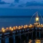 A dreamy candlelit pier overlooking the ocean at The Lombok Lodge, the perfect setting for a romantic honeymoon in Lombok