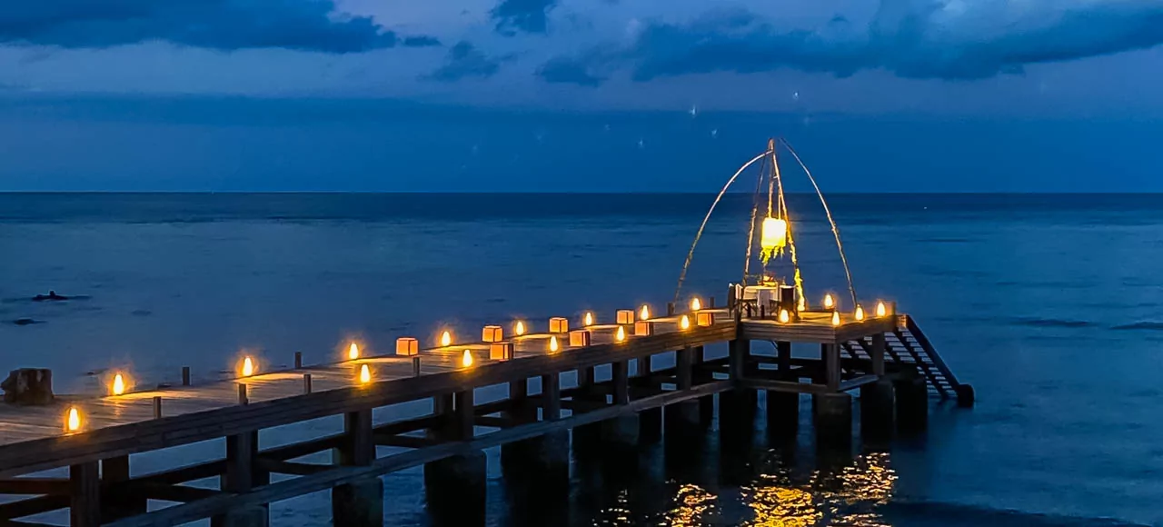 A dreamy candlelit pier overlooking the ocean at The Lombok Lodge, the perfect setting for a romantic honeymoon in Lombok