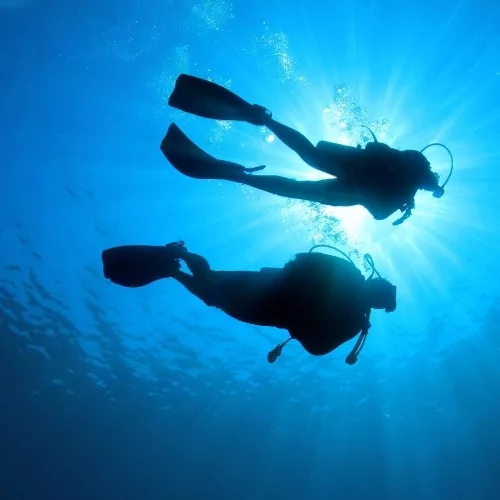 wo scuba divers exploring the deep blue waters of Lombok, Indonesia.