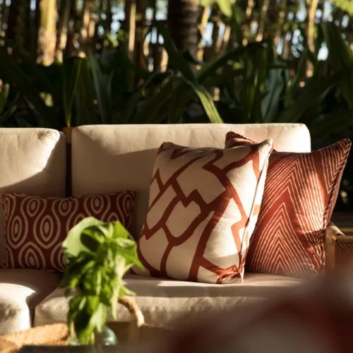 Outdoor sofa with patterned cushions at Nihi Sumba Resort villa