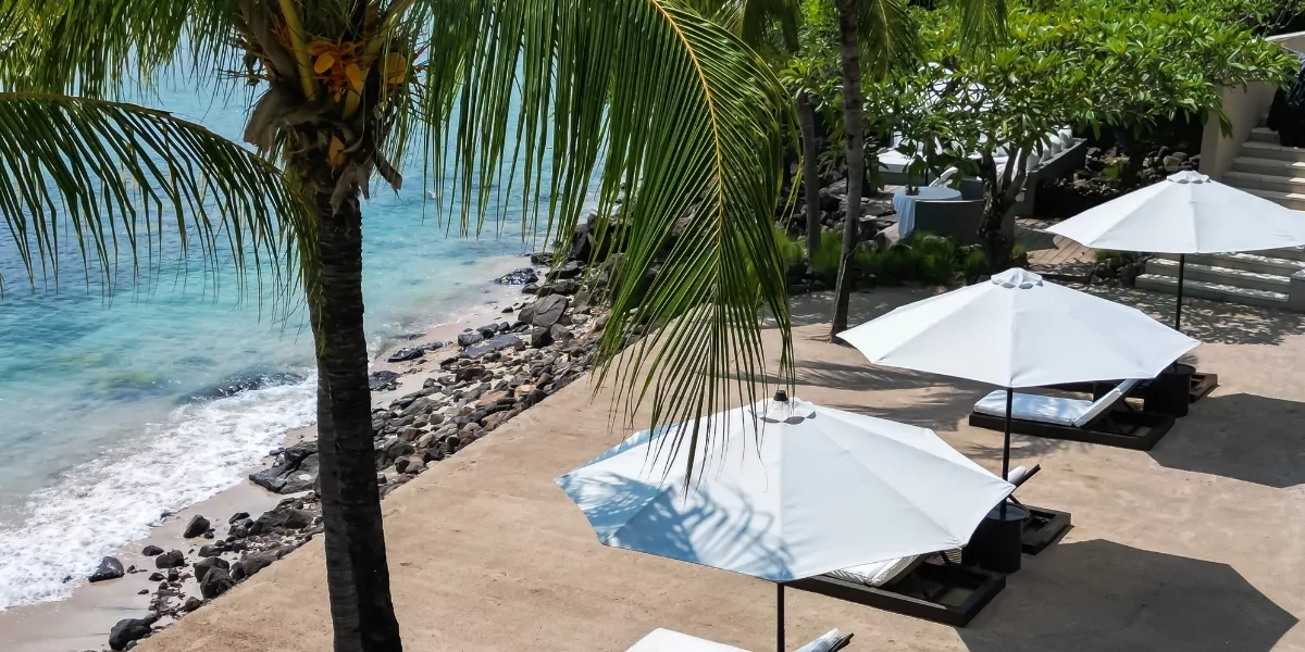 The Lombok Lodge Boutique Hotel Beach are with classy white umbrellas